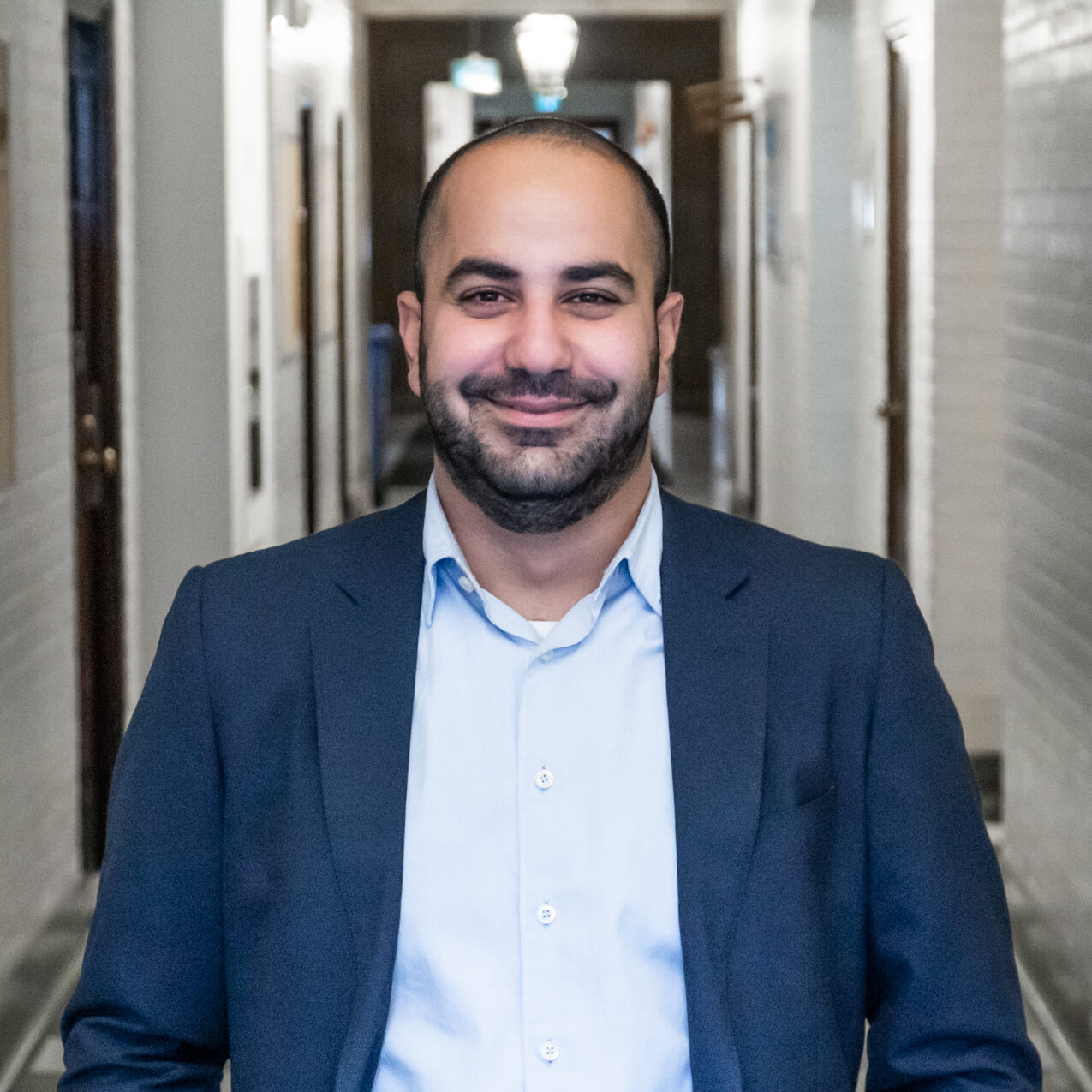 The IMPACT Center innovator, Emile Maamary Headshot, Man in blue suit smiling at camera