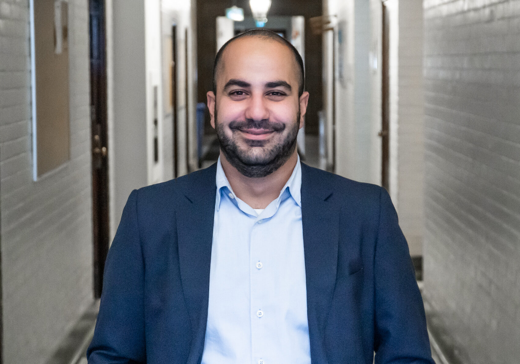 The IMPACT Center innovator, Emile Maamary Headshot, Man in blue suit smiling at camera