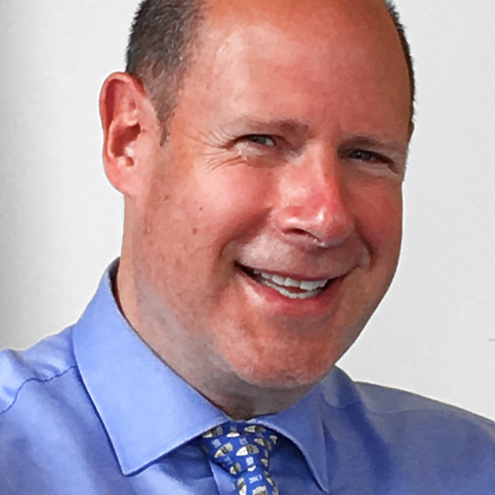 The IMPACT Center Testimonials page. Ian M. (IMPACT Center Mentor). White male wearing a blue dress shirt and blue tie.
