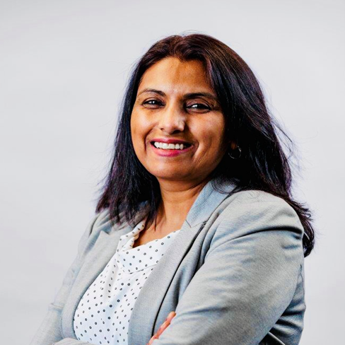Malabika Sen headshot. woman in Gray suit with dark hair